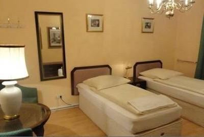 Zweibettzimmer mit dunklen Holzmöbeln