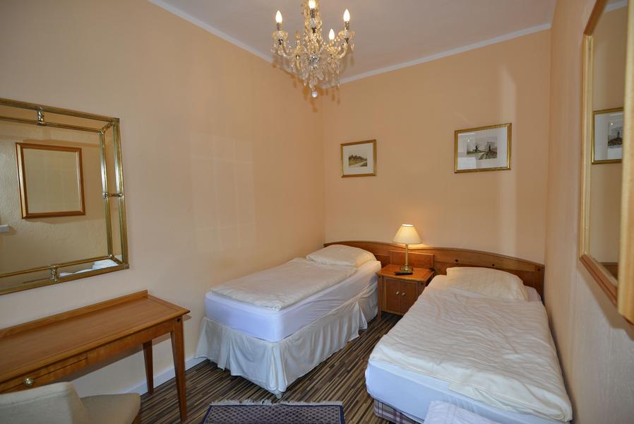 Zweibettzimmer mit Wischtechnik-Wandgestaltung und Kronleuchter